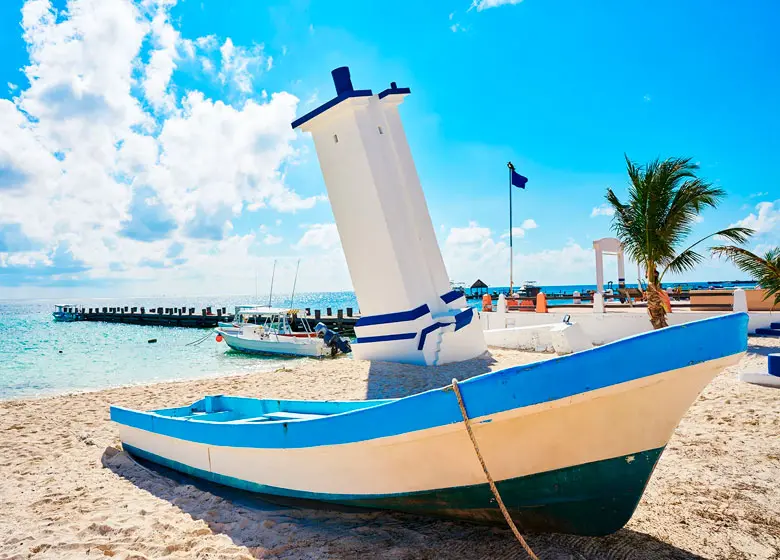 Boat in front of the mythical lighthouse of Puerto Morelos